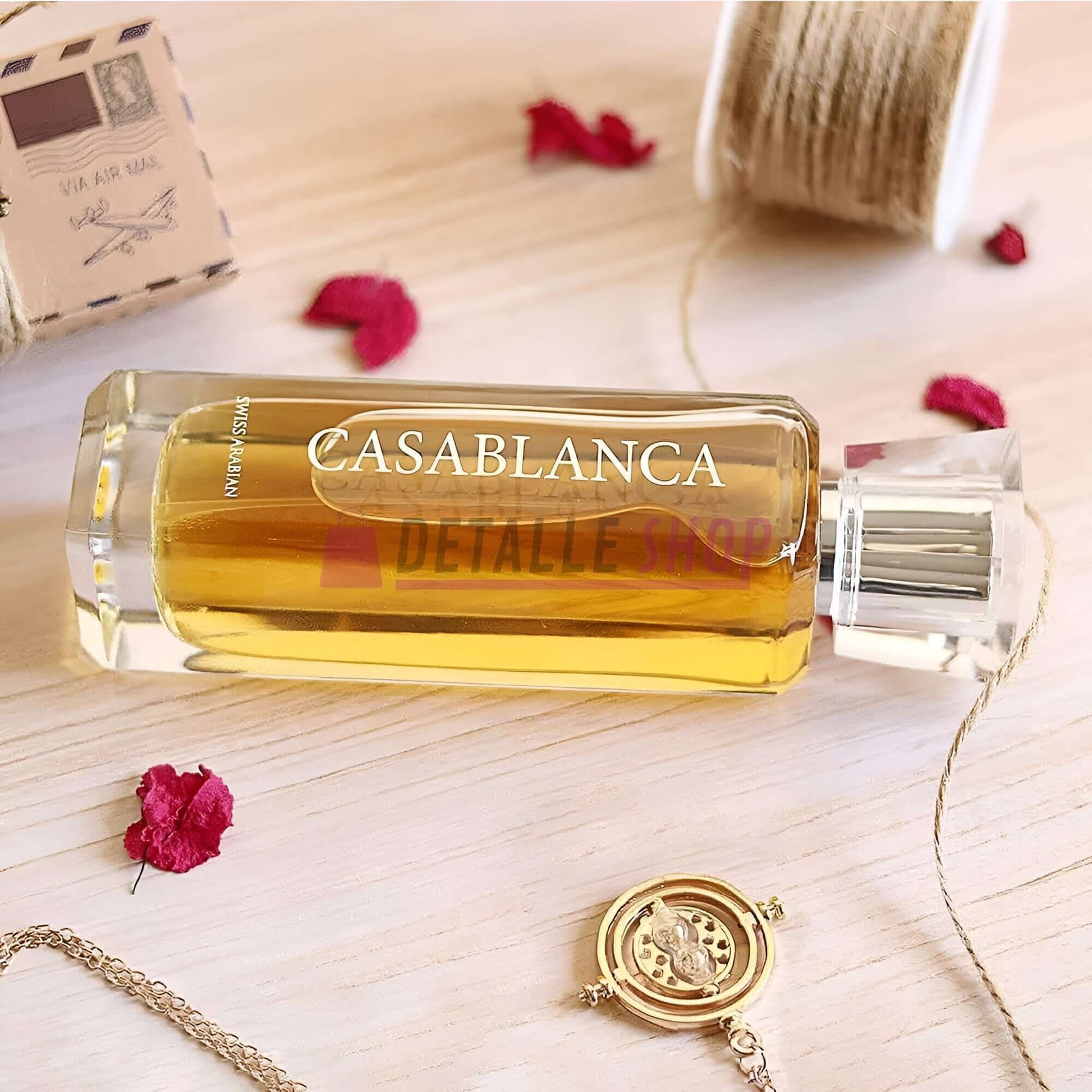 Casablanca de Swiss Arabian perfume 100ml bottle on a wooden surface with decorative elements.